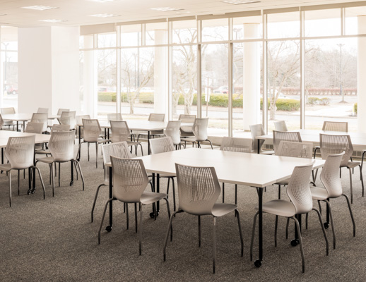 Knoll Antenna simple tables with black legs and MultiGeneration by Knoll chairs for a café